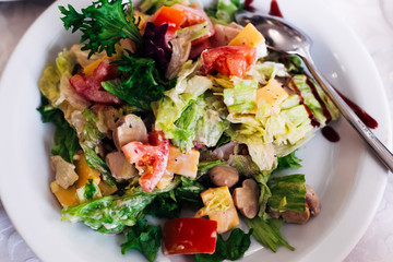 top view of appetizing salad of vegetables, lettuce and cheese.