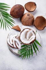 Fototapeta na wymiar Sliced coconut and palm leaves