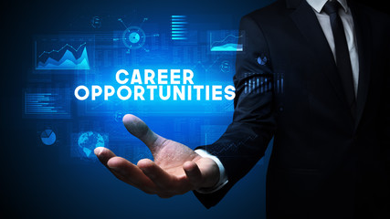 Hand of Businessman holding CAREER OPPORTUNITIES inscription, business success concept
