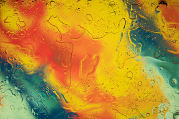 Oil and water mixed together creates an abstract colourful picture