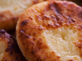 Cottage cheese pancakes are photographed close up as a background. Delicious cheesecake with a Golden crust photographed close-up