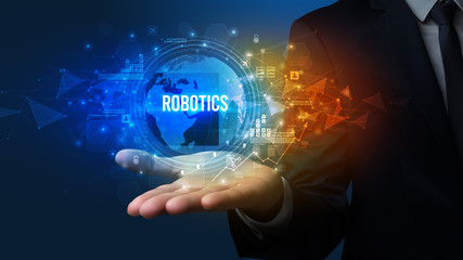 Elegant hand holding ROBOTICS inscription, digital technology concept