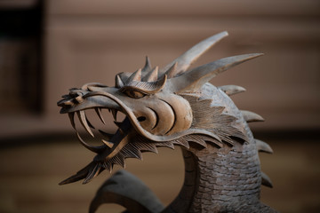 wooden oriental dragon with open mouth