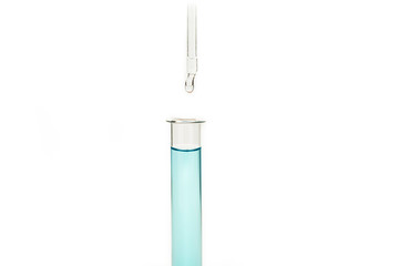 Dripping reagent into test tube with liquid sample