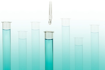 Dripping reagent into test tube with liquid sample