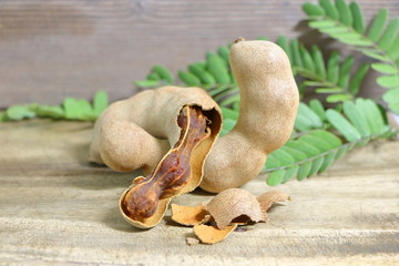 Brown ripe tamarind on wood table background in Thailand