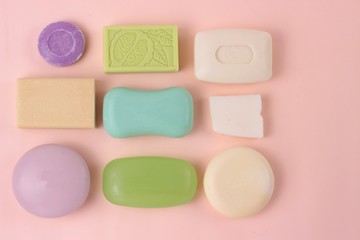 Hygiene and prevention of viral diseases concept. Various soap bar on a pink background. Top view with copy space