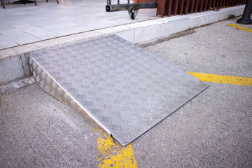 Ramp for disabled persons on wheelchair at building entrance.