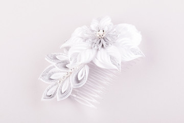 a beautiful hair comb in the form of flowers from kanzashi ribbons