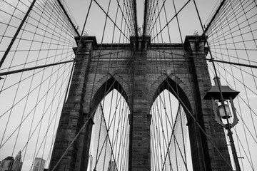 Grayscale low angle shot of a Brooklyn Bridge in New York City
