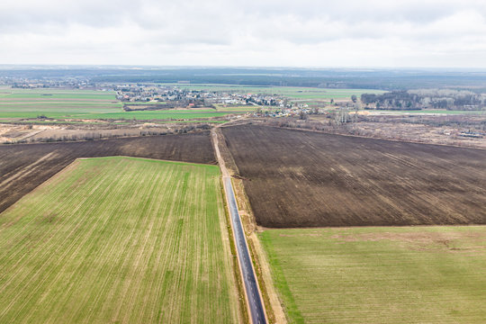 Nowy Dwor, Poland aerial view near airport with rural winter brown green landscape countryside town village near Warsaw and farm fields highway road
