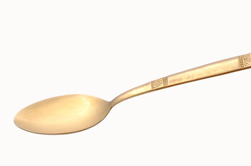 Golden spoon isolated on white background
