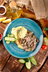 meat goulash is served with mashed potatoes and vegetables