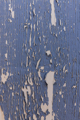 beige Fläche aus Holz mit blauer Farbe die abblättert mit Struktur und Textur