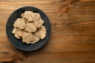 Raw Dehydrated Soy Meat or Soya Chunks on Wood Background