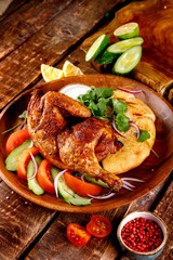 fried chicken with vegetables and bread on a plate