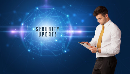 Businessman thinking about security solutions with SECURITY UPDATE inscription