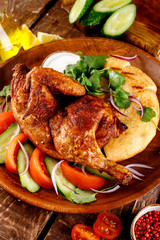 fried chicken with vegetables and bread on a plate