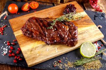 rib eye steak with margarine on a cutting Board