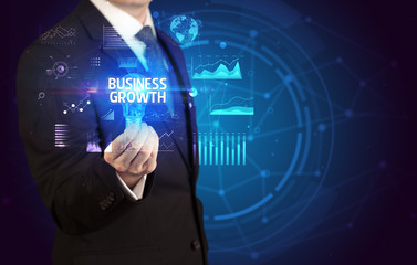 Businessman holding lightbulb with BUSINESS GROWTH inscription, Business idea concept