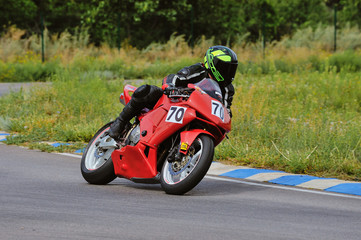 Fototapeta na wymiar Motorcycle practice leaning into a fast corner on track