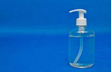 Antiseptic bottle, latex gloves, face mask on blue background, for coronavirus prevention