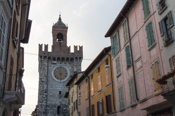 Fototapeta na wymiar Narrow street with upper facad of Torre della Pallata, Brescia Old Town, Lombardy, Italy.