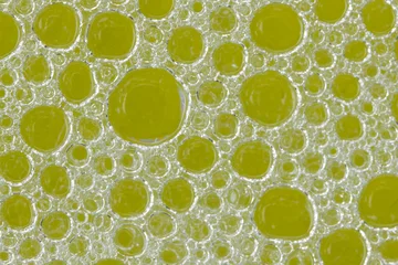 Foto auf Acrylglas round oily soap bubbles on a yellow background © LauraFokkema