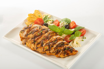 Italian style marinated chicken breast with fresh salads and tomato catchup on a white rectangle plate