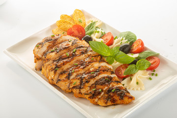 Italian style marinated chicken breast with fresh salads and tomato catchup on a white rectangle plate