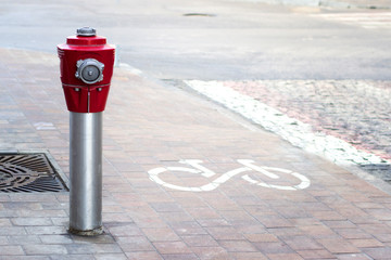 The old red fire hydrant on a city street.