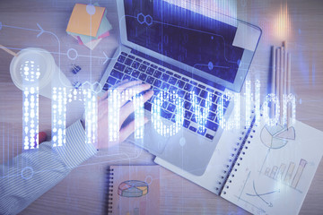 Multi exposure of man's hands typing over computer keyboard and data theme hologram drawing. Top view. Technology concept.