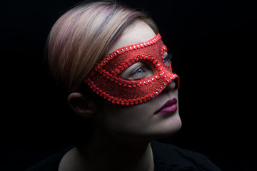 Beautiful sexy woman with red mask. 50 shades of grey concept