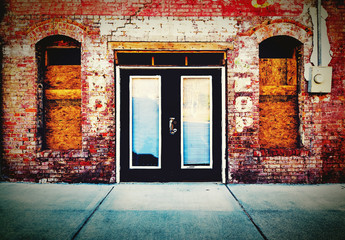A closeup of double doors on an old brick storefront in Garner, North Carolina.