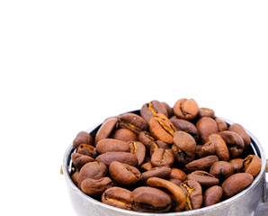 roasted coffee beans in scoop isolated on white background
