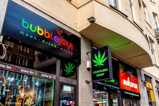 Warsaw, Poland - January 22, 2020: Road sign for Cannabis shop and bubblejoy restaurant in downtown old town Warszawa on Chmielna street