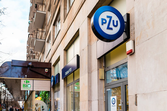 Warsaw, Poland - January 22, 2019: Sign for PZU insurance company and Carrefour bio organic green grocery supermarket on street in downtown center