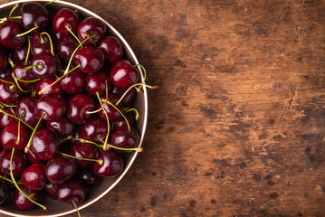 Ripe cherries on a wooden table - panoramic background with copy space