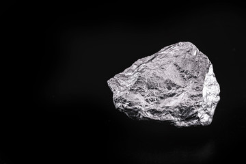 silver nugget native to Liberia isolated on black background.