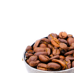 roasted coffee beans in scoop isolated on white background
