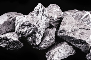 Raw manganese. Manganese stone isolated on black background. Mineral extraction of heavy metals...