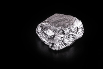 small titanium stone, metal used in light alloys. Macro photography of rough ore.