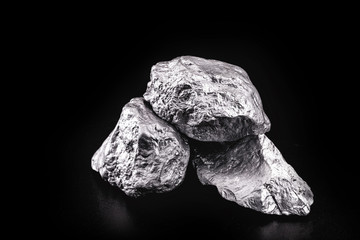 large silver stone, rare silver nugget on black background. Gemstone in high resolution, luxury concept.