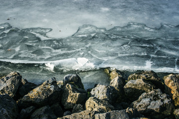 Stone coast of a frozen lake in winter