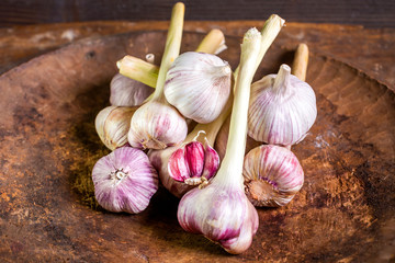 View of lots of heads of garlic on wooden background, healthy food