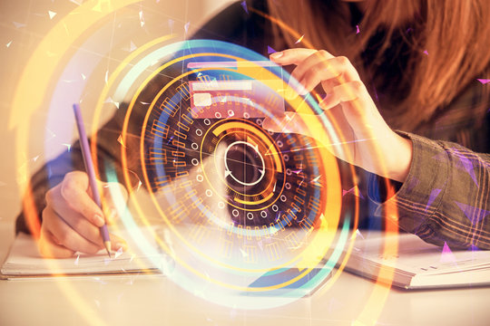 Multi exposure of woman on-line shopping holding a credit card and tech theme drawing. Technology concept.