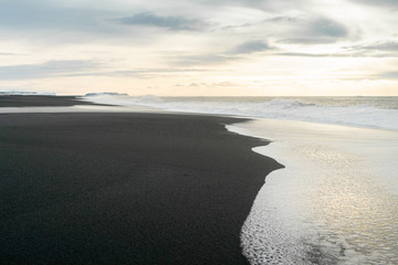 Sunrise on the black sand beach in Iceland in winter, Reynisfjara 