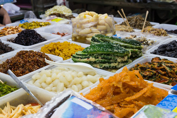 Asian vegetables and food offered at a market in Okinawa.