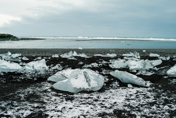 Diamond beach on Iceland or Jokulsarlon Iceberg beach. Crystal ice melting on volcanic beach In Iceland.
