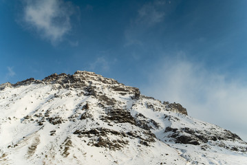 Winter in Iceland at the foot of the volcano. Snowy Icelandic mountain